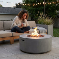 Westport 34 In. X 14 In. Grey round Concrete Propane Pit Table with Electronic Ignition Cover and Lava Rock — Lifestyle
